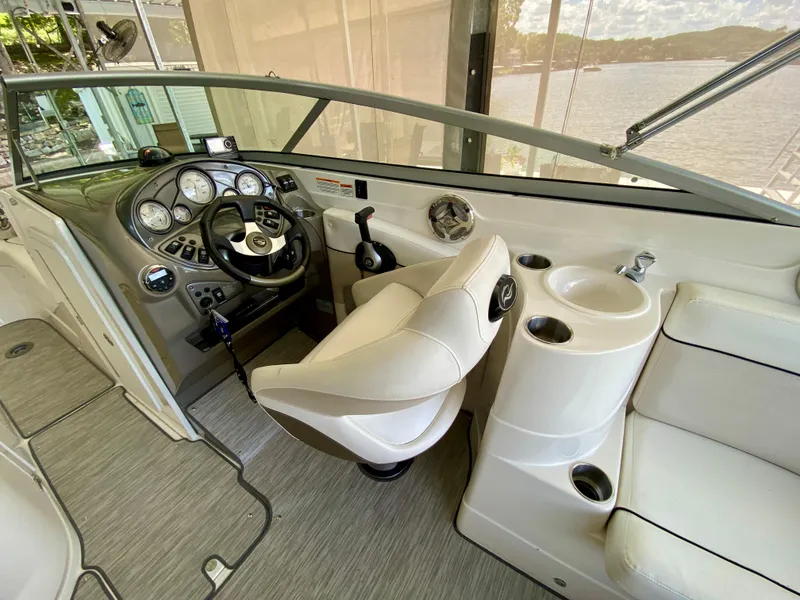 Slide: The Image of 2008 Rinker 246 Captiva Bowrider cockpit with steering wheel, gauges, and seating. - 17