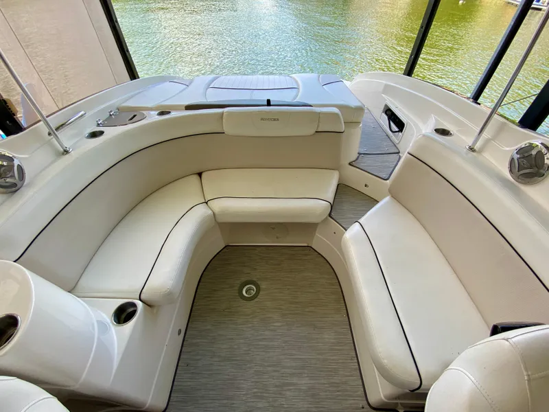 Slide: The Image of 2008 Rinker 246 Captiva Bowrider interior with white seating and lake view. - 20