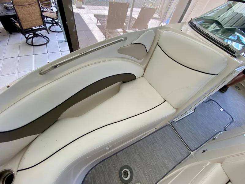 Slide: The Image of 2008 Rinker 246 Captiva Bowrider interior with white seating and sleek design. - 23