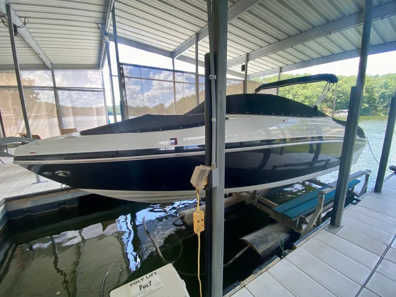 The Image of 2008 Rinker 246 Captiva Bowrider boat docked in a covered marina. - 5