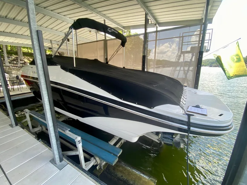 Slide: The Image of 2008 Rinker 246 Captiva Bowrider docked under a covered slip on a sunny day. - 7