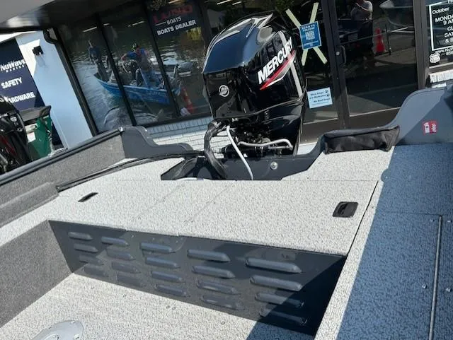 Slide: The Image of 2026 Lund 1650 Angler SS boat with Mercury engine displayed at dealership. - 10