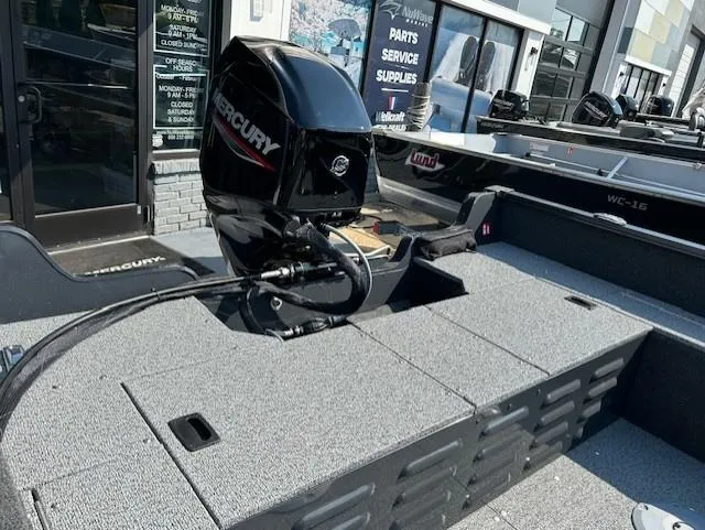 Slide: The Image of 2026 Lund 1650 Angler SS boat with Mercury engine, displayed at a dealership. - 7