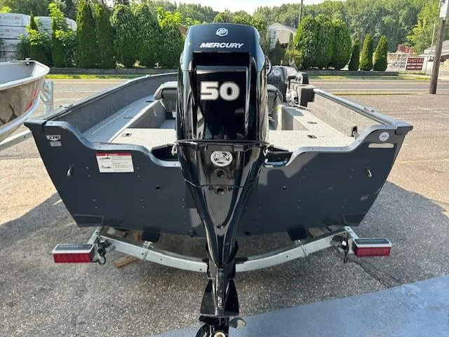 Slide: The Image of 2026 Lund 1650 Angler SS boat with Mercury 50 outboard motor, parked outdoors. - 8