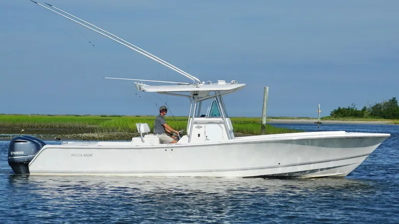 Slide: The Image of 2006 Regulator 32 FS boat on calm water with Yamaha engines. - 12