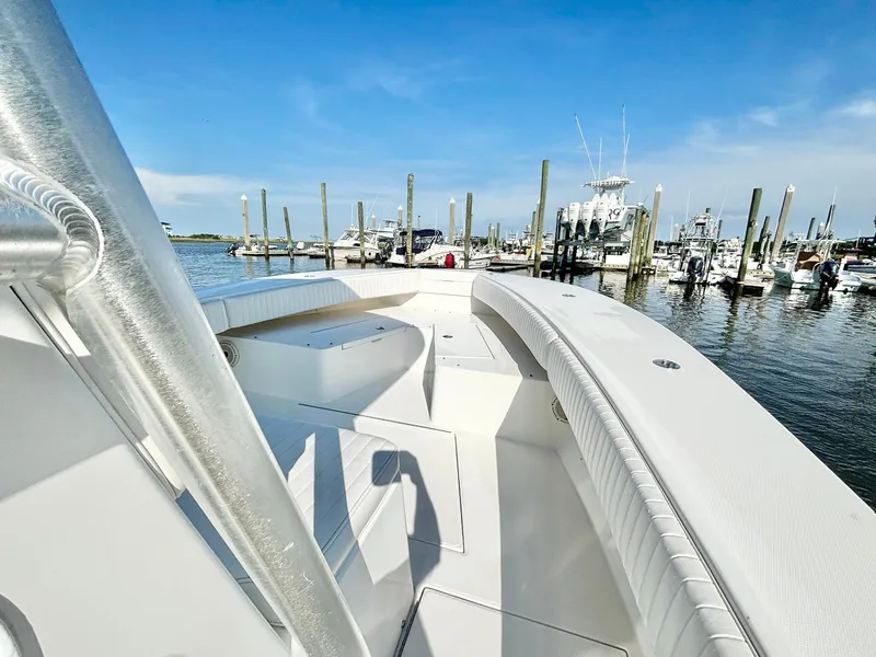 Slide: The Image of 2006 Regulator 32 FS boat docked at a marina under clear blue skies. - 15