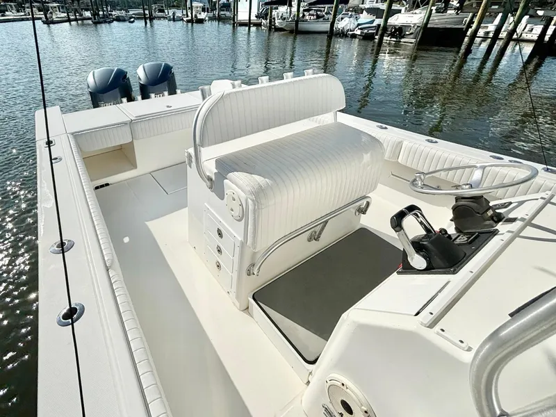 Slide: The Image of 2006 Regulator 32 FS boat interior with dual engines, docked at marina. - 17