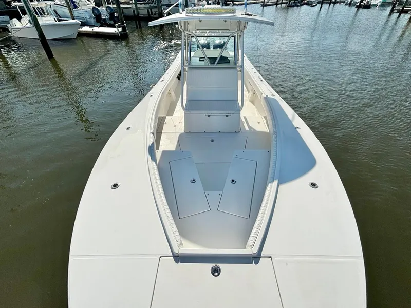 Slide: The Image of 2006 Regulator 32 FS boat docked in a marina, showcasing spacious deck and seating. - 18