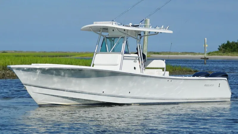 Slide: The Image of 2006 Regulator 32 FS boat on calm water, clear sky background. - 6