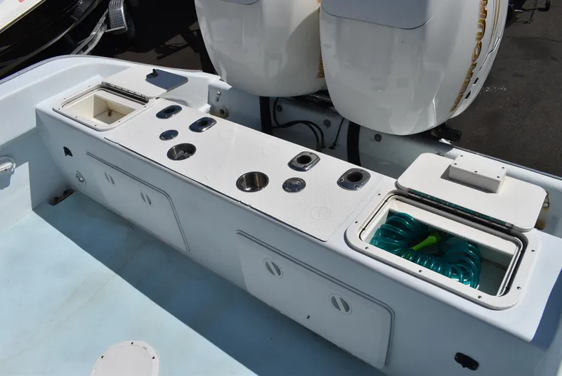 Slide: The Image of 2006 Cape Horn 27 CC boat deck with storage compartments and dual engines. - 14