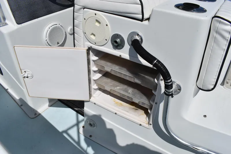 Slide: The Image of Open storage compartment on 2006 Cape Horn 27 CC boat with visible trays and speakers. - 15