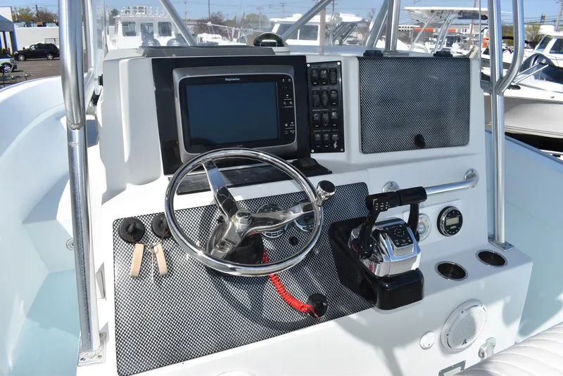 Slide: The Image of 2006 Cape Horn 27 CC boat dashboard with steering wheel and navigation controls. - 16