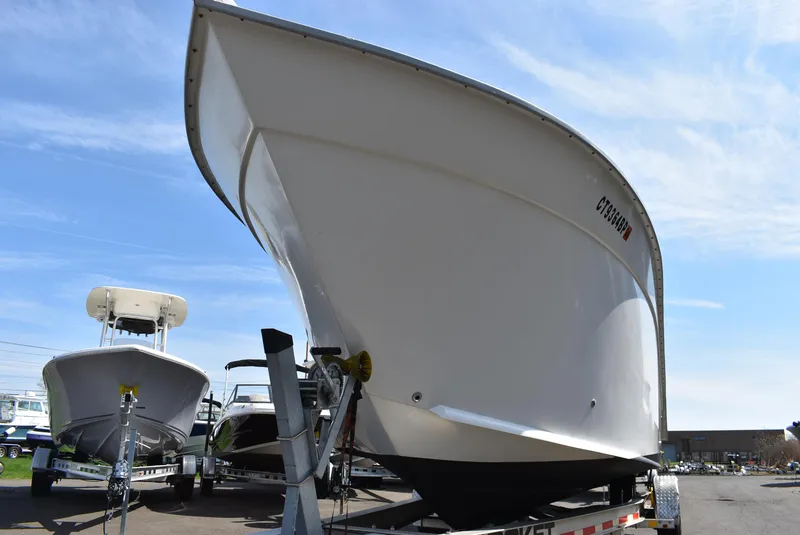 Slide: The Image of 2006 Cape Horn 27 CC boat on trailer, displayed outdoors under clear sky. - 21