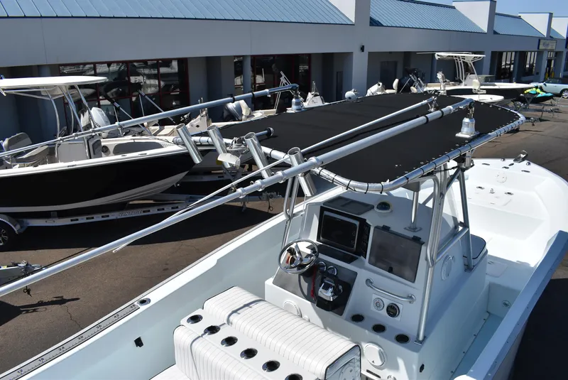 Slide: The Image of 2006 Cape Horn 27 CC boat with black canopy and modern dashboard, docked at a marina. - 8