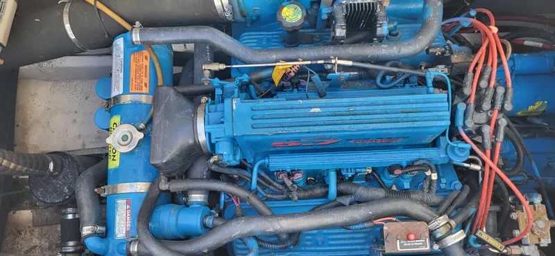 Slide: The Image of Engine of a 2000 Carver 350 Mariner boat, featuring blue components and wiring. - 11