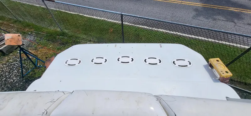 Slide: The Image of Top view of a 2000 Carver 350 Mariner boat deck near a fence. - 13