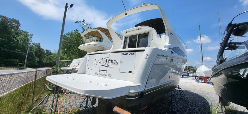 Slide: The Image of 2000 Carver 350 Mariner yacht on dry dock under clear blue sky. - 14