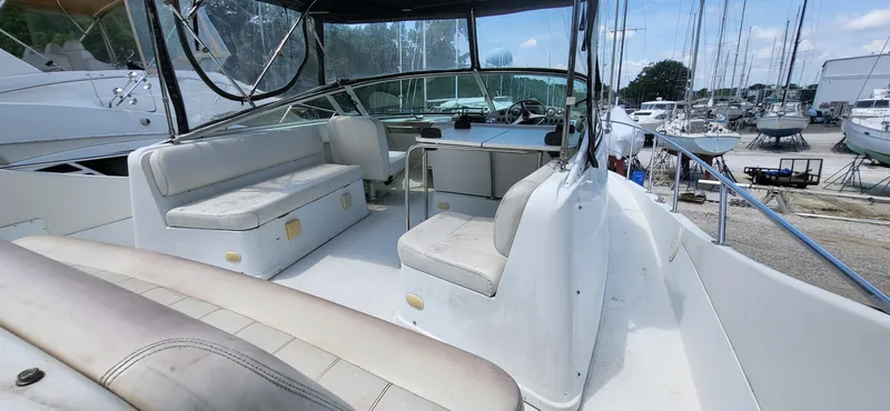 Slide: The Image of 2000 Carver 350 Mariner yacht interior with seating and helm, docked in a marina. - 15