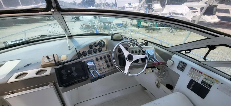 Slide: The Image of Cockpit of 2000 Carver 350 Mariner yacht with steering wheel and control panel. - 16