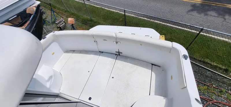 Slide: The Image of Carver 350 Mariner 2000 boat deck with white seating and storage compartments. - 2