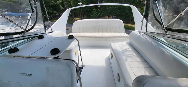 Slide: The Image of 2000 Carver 350 Mariner yacht interior with white seating and table, surrounded by clear enclosures. - 20