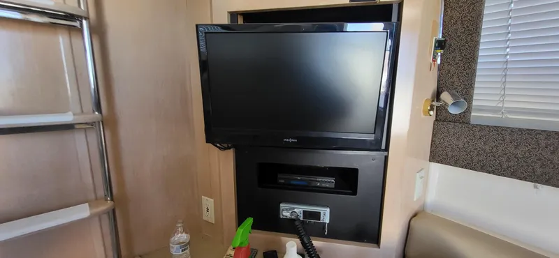 Slide: The Image of Entertainment setup inside a 2000 Carver 350 Mariner yacht with TV and stereo system. - 21