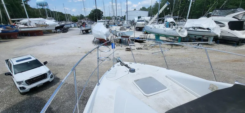 Slide: The Image of Boat yard with Carver 350 Mariner 2000, surrounded by various boats and a white SUV. - 23