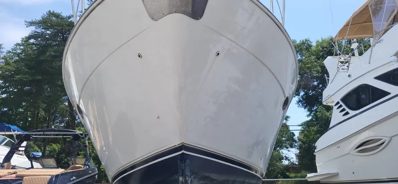Slide: The Image of Front view of a 2000 Carver 350 Mariner yacht, docked with trees in the background. - 26