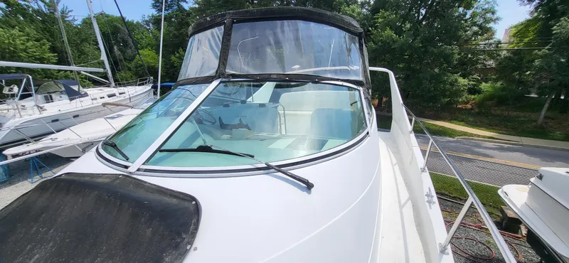 Slide: The Image of 2000 Carver 350 Mariner boat with sleek design, docked outdoors. - 27