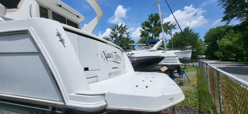 Slide: The Image of 2000 Carver 350 Mariner yacht docked outdoors under a clear blue sky. - 3