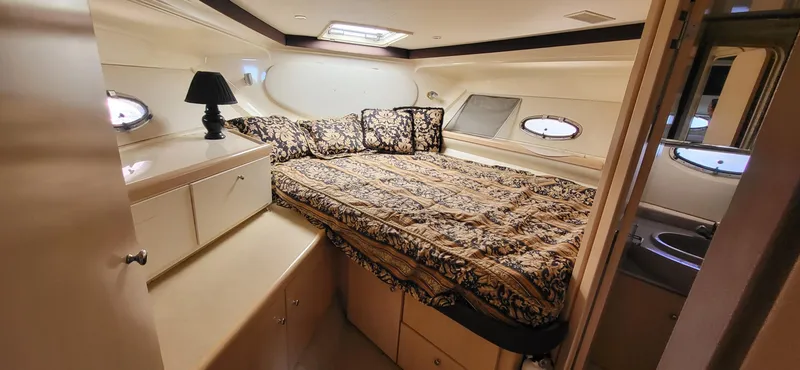 Slide: The Image of Luxurious cabin interior of 2000 Carver 350 Mariner yacht with elegant bedding. - 4
