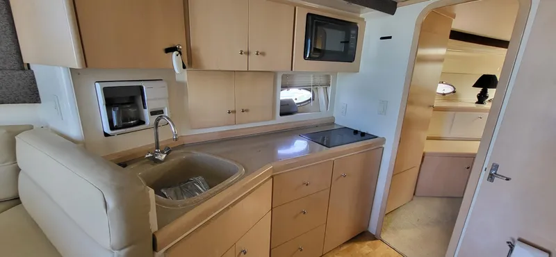 Slide: The Image of Interior of 2000 Carver 350 Mariner yacht with kitchenette and modern amenities. - 5
