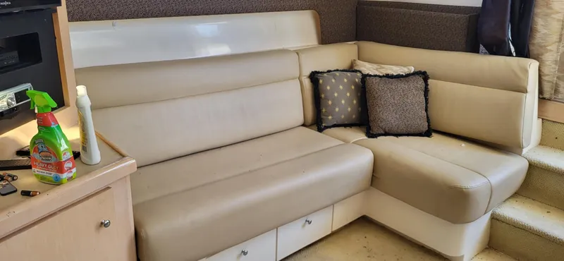 Slide: The Image of Interior of a 2000 Carver 350 Mariner with beige seating and decorative pillows. - 6
