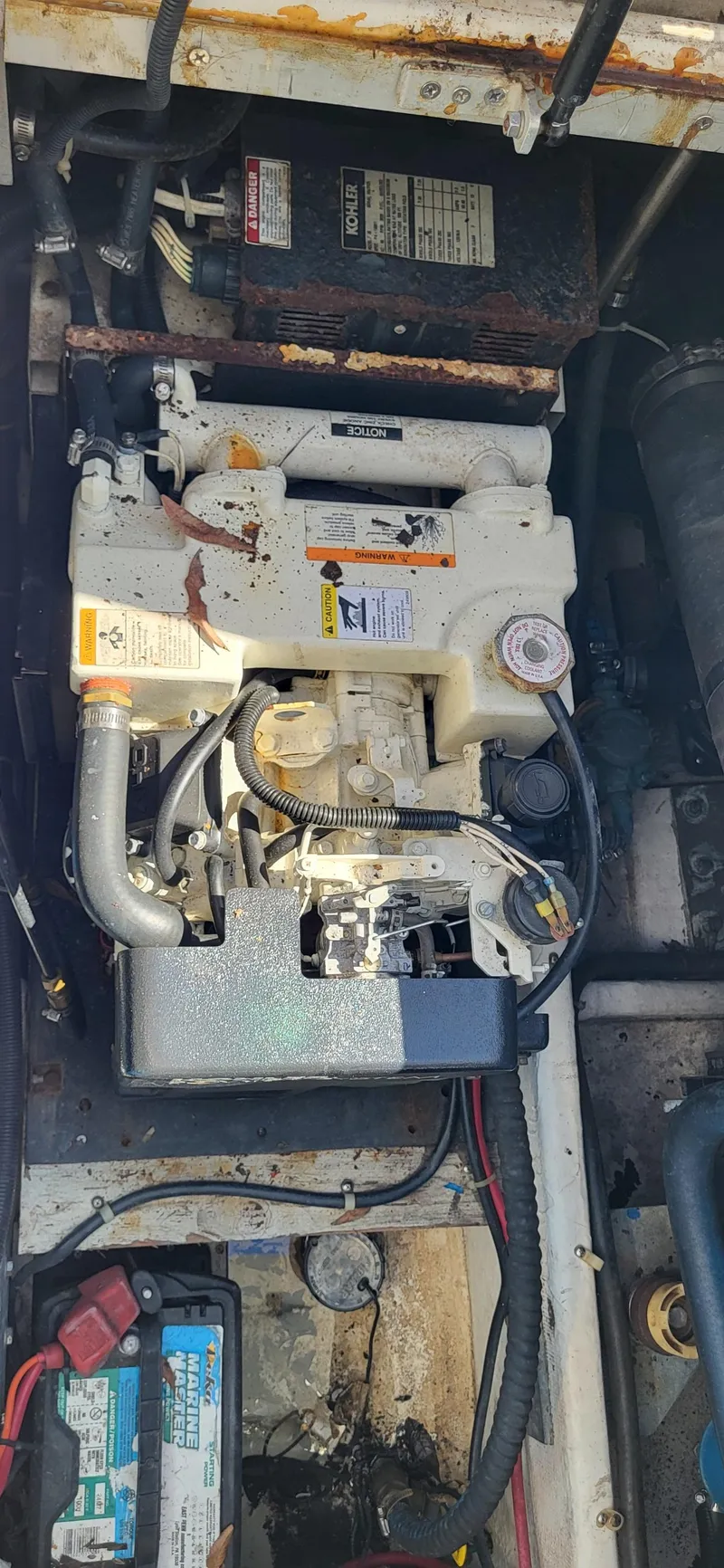 Slide: The Image of Engine compartment of a 2000 Carver 350 Mariner boat, showing mechanical components. - 7