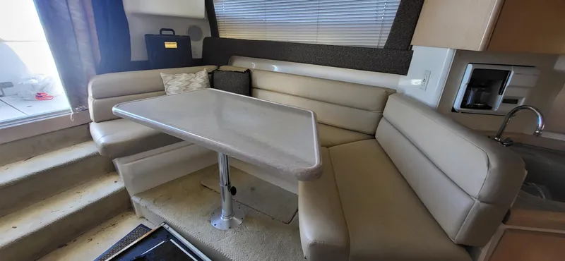 Slide: The Image of Interior of 2000 Carver 350 Mariner yacht with beige seating and table. - 9