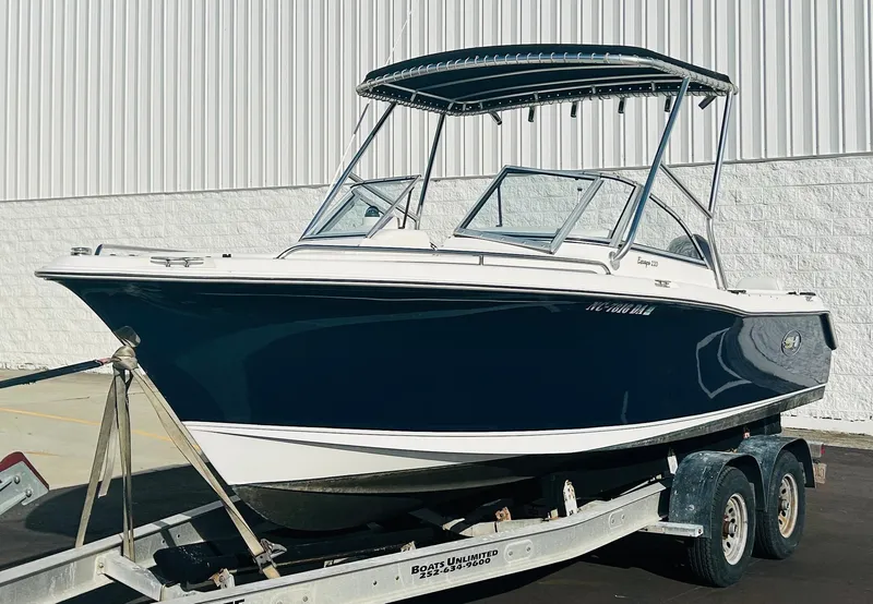 Slide: The Image of 2005 Sea Hunt Escape 220 boat on trailer, parked outdoors. - 2