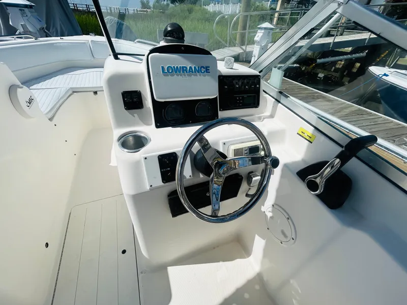 Slide: The Image of 2005 Sea Hunt Escape 220 boat cockpit with steering wheel and Lowrance electronics. - 6
