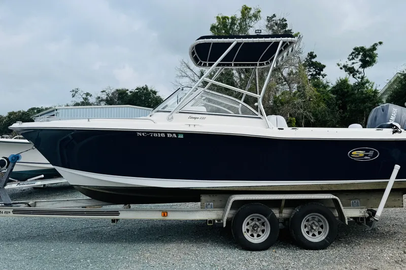 Slide: The Image of 2005 Sea Hunt Escape 220 boat on trailer, side view, with canopy and Yamaha engine. - 9