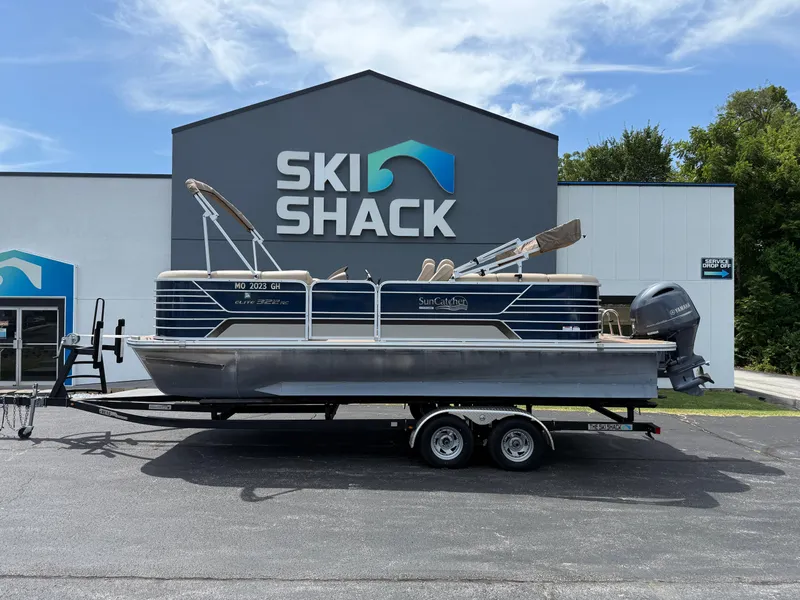 Slide: The Image of 2018 SunCatcher Elite 322 RC pontoon boat on trailer at Ski Shack dealership. - 0