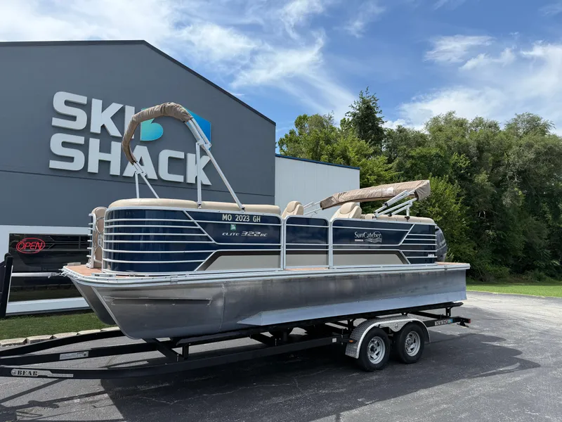 Slide: The Image of 2018 SunCatcher Elite 322 RC pontoon boat on trailer at Ski Shack dealership. - 1