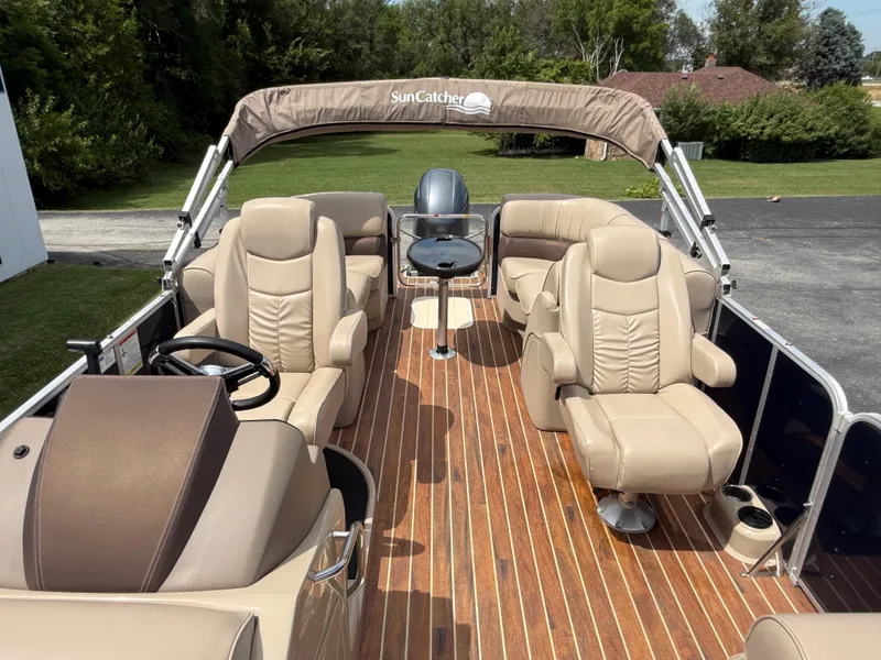 Slide: The Image of 2018 SunCatcher Elite 322 RC pontoon boat with luxurious seating and wood-style flooring. - 11