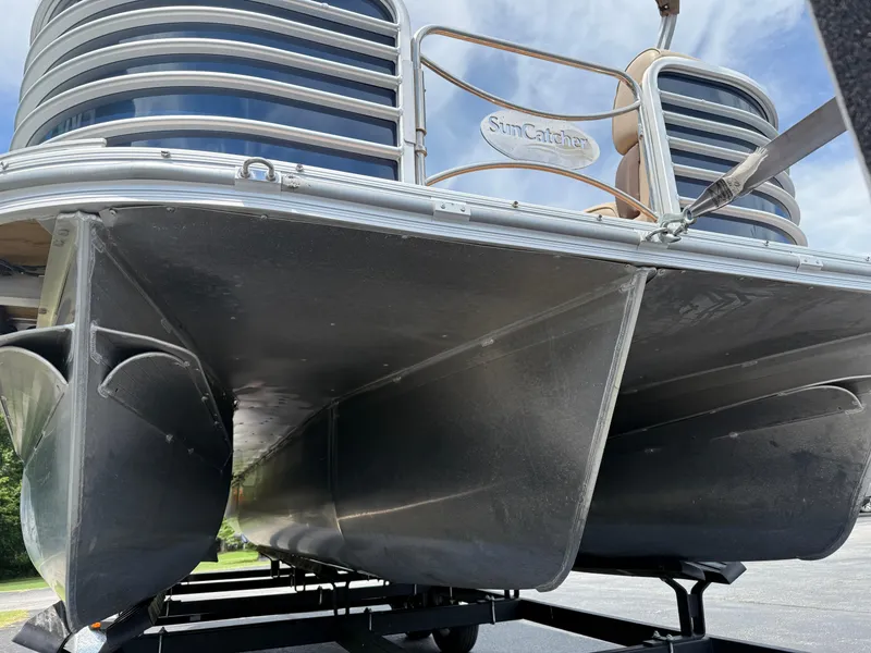Slide: The Image of 2018 SunCatcher Elite 322 RC pontoon boat on trailer, viewed from below. - 2