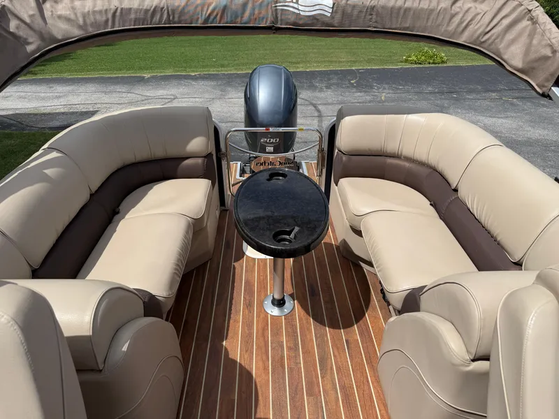 Slide: The Image of 2018 SunCatcher Elite 322 RC pontoon boat interior with plush seating and wood-style flooring. - 21