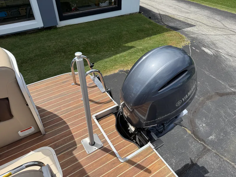 Slide: The Image of 2018 SunCatcher Elite 322 RC boat with Yamaha outboard motor on wooden deck. - 22