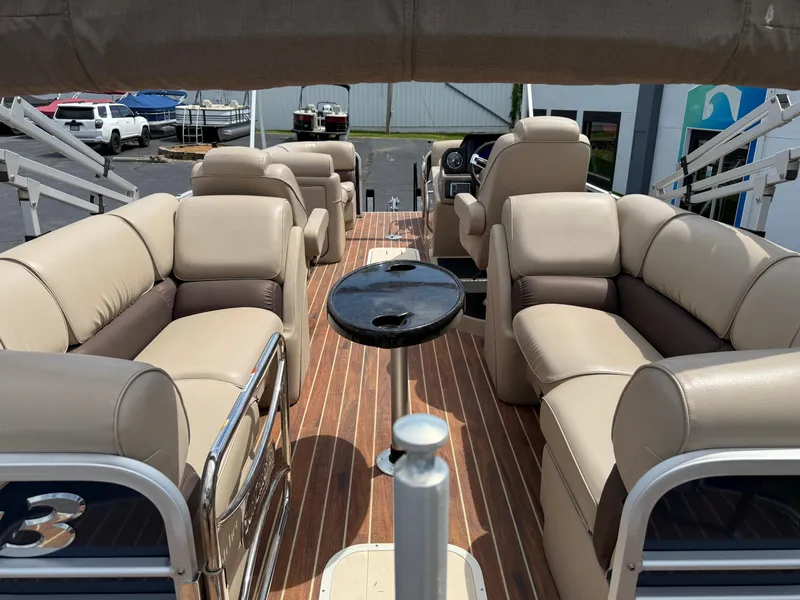 Slide: The Image of 2018 SunCatcher Elite 322 RC pontoon boat with luxurious seating and wood-style flooring. - 23