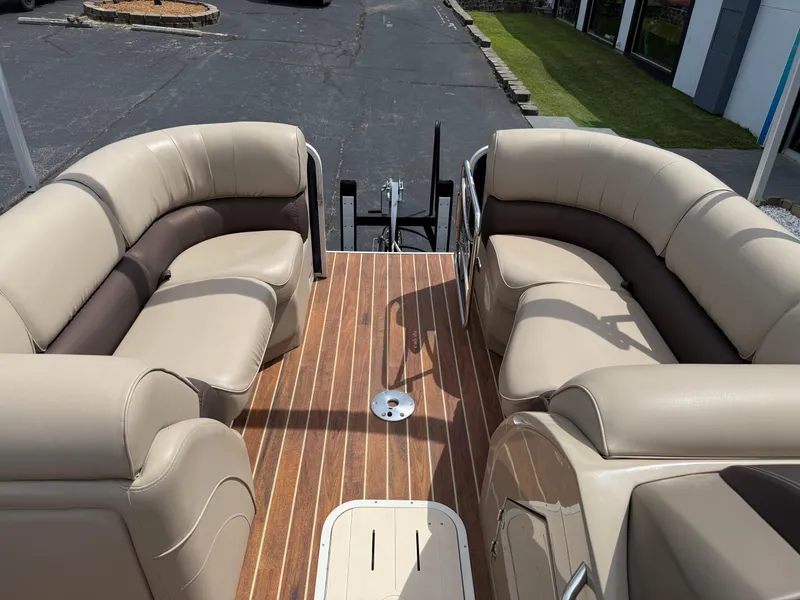 Slide: The Image of 2018 SunCatcher Elite 322 RC pontoon boat with beige seating and wood-style flooring. - 25