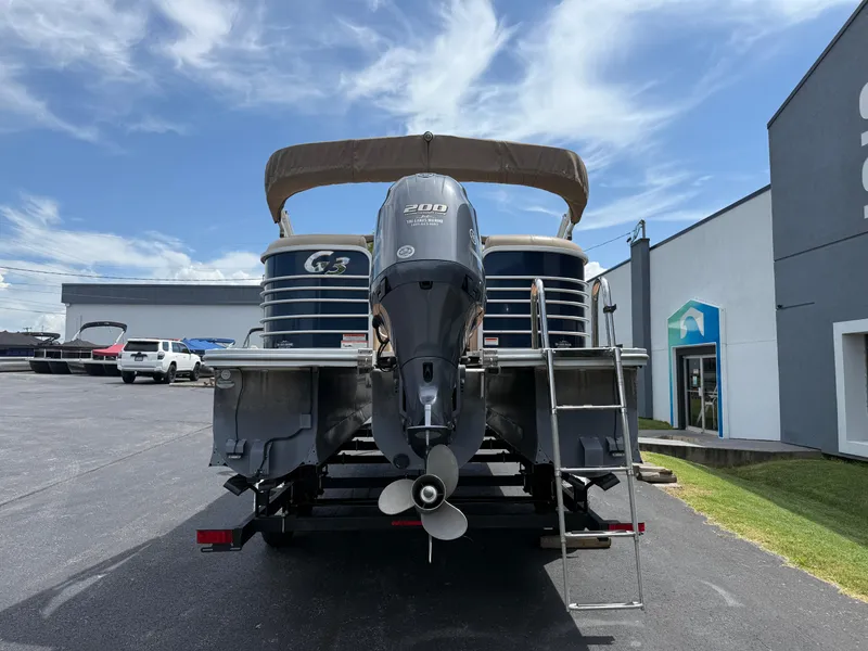 Slide: The Image of 2018 SunCatcher Elite 322 RC pontoon boat with Yamaha 200 engine, parked outdoors. - 5