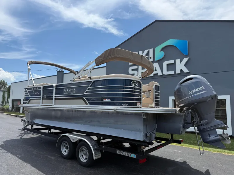 Slide: The Image of 2018 SunCatcher Elite 322 RC pontoon boat on trailer outside dealership. - 6