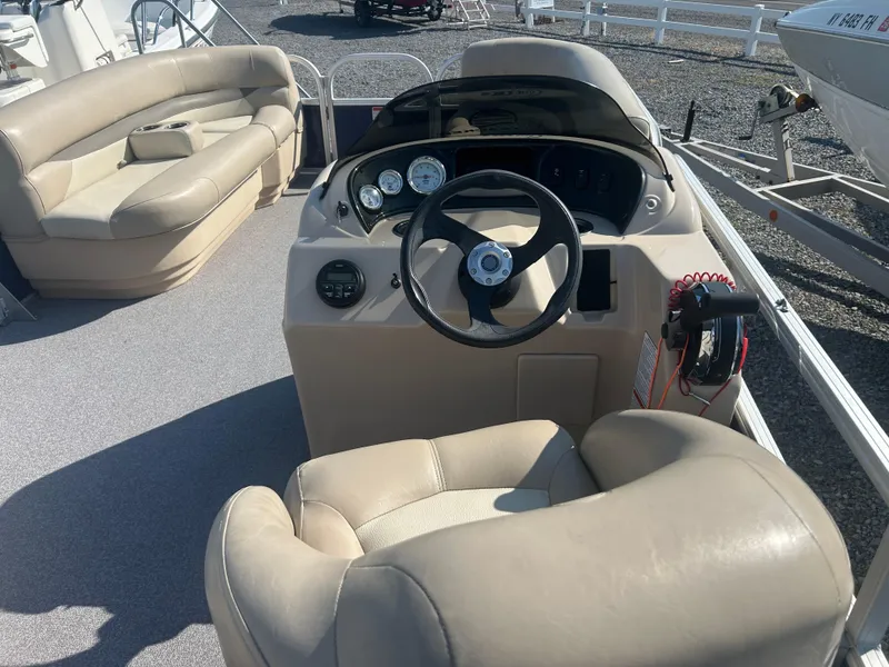 Slide: The Image of 2016 Sun Tracker Party Barge 18 DLX interior with steering console and seating. - 14