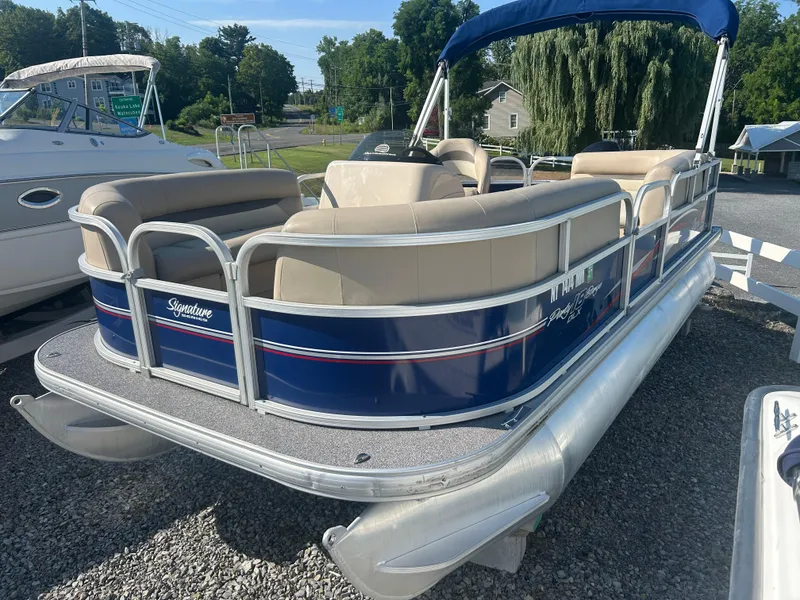 Slide: The Image of 2016 Sun Tracker Party Barge 18 DLX pontoon boat with blue and beige seating. - 2